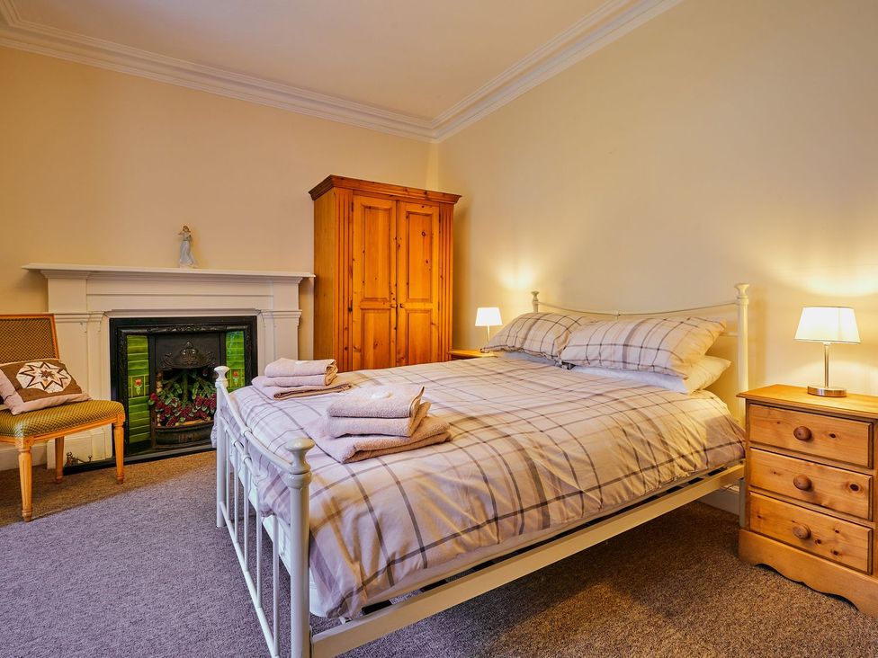A bedroom with a bed and wardrobe at West Lodge Kirriemuir