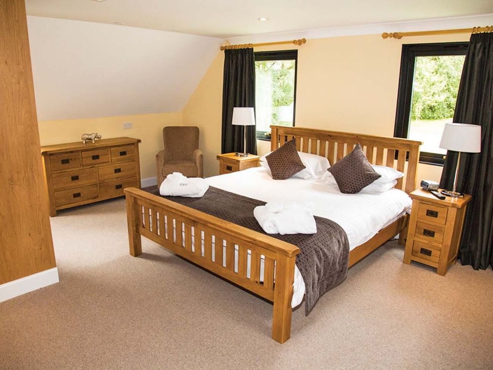 A bedroom with a bed and furniture at The Derwent (Pet) Slaley