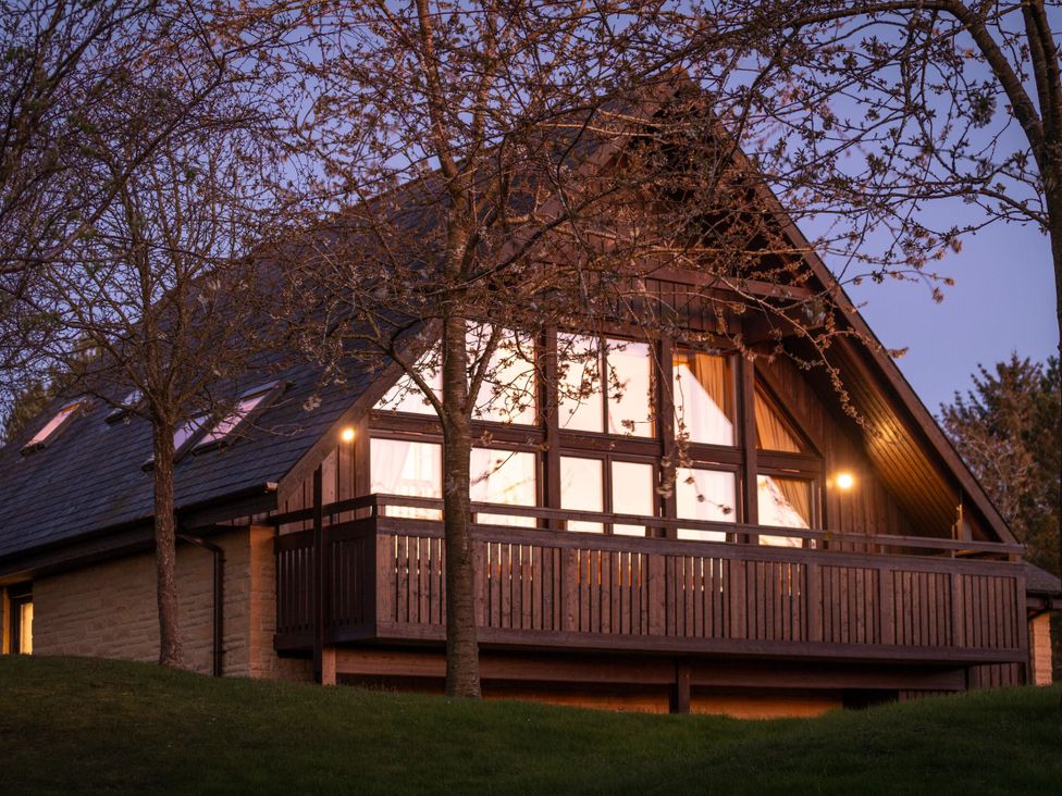 A house with a balcony and trees at The Hexham in Slaley