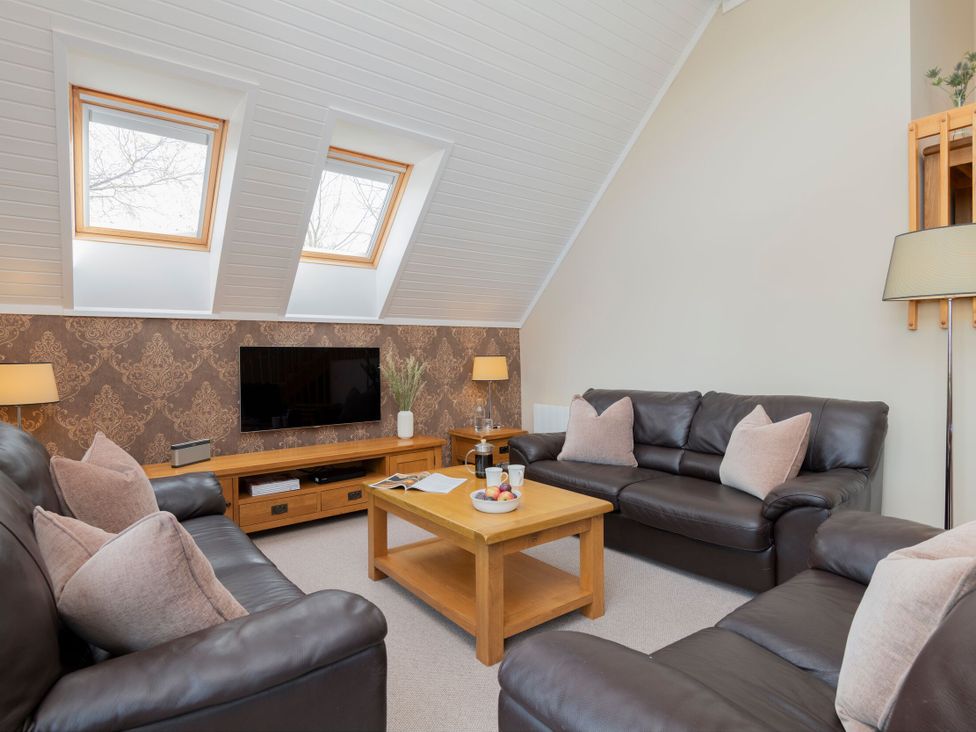 A living room with a television and seating area at The Hexham (Pet) in Slaley