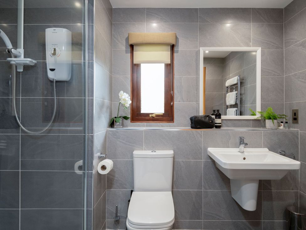 A bathroom with a shower toilet and sink at The Hexham (Pet) in Slaley