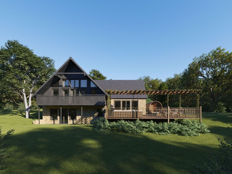 A house with a deck and pergola surrounded by trees at Heatherwood (Pet) Slaley
