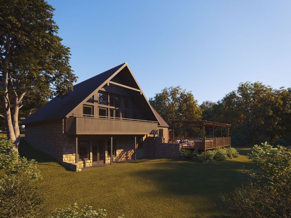 A house with a deck and trees in the background at Heatherwood (Pet) Slaley