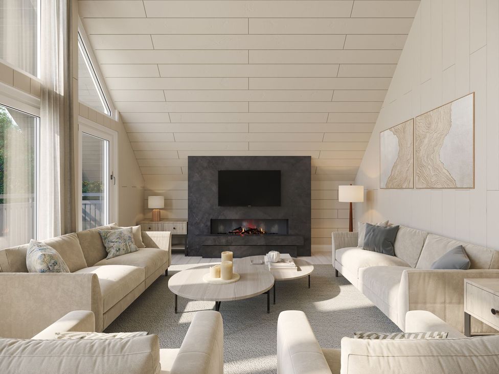 A living room with a fireplace and sofas at Heatherwood (Pet) in Slaley
