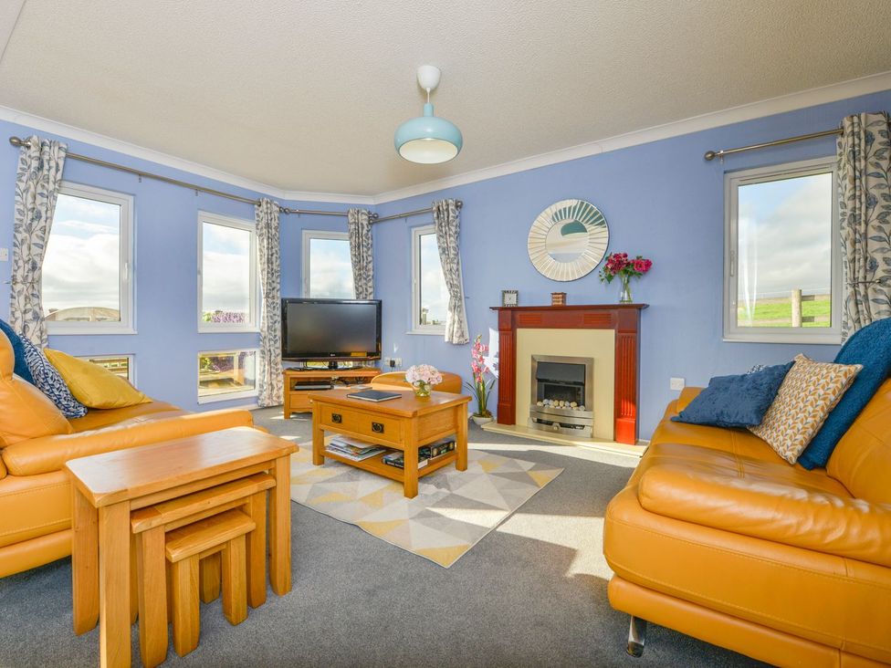A living room with a sofa and coffee table at Dartmoor View in Exeter