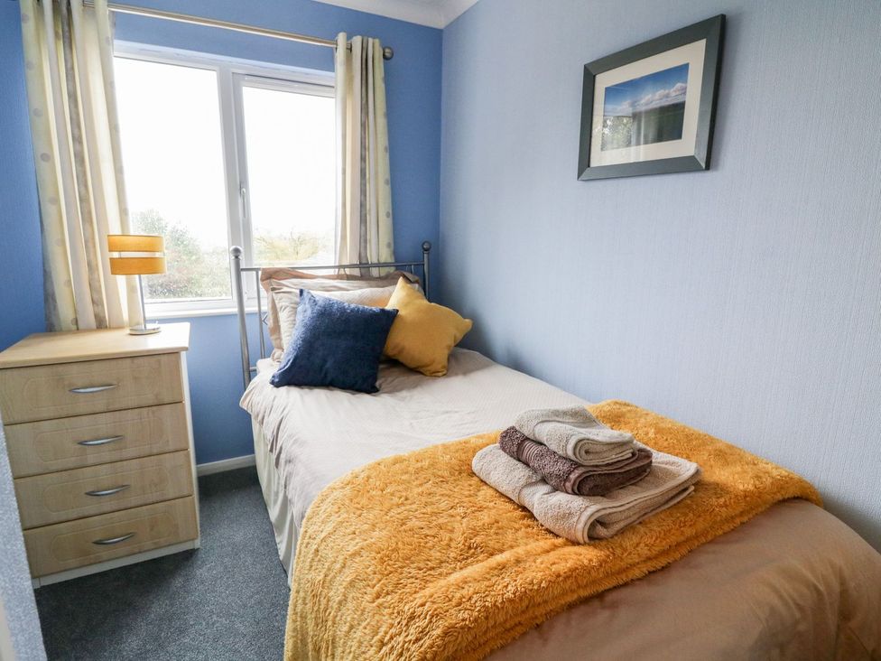 A bedroom with a bed and towels on it at Dartmoor View in Exeter