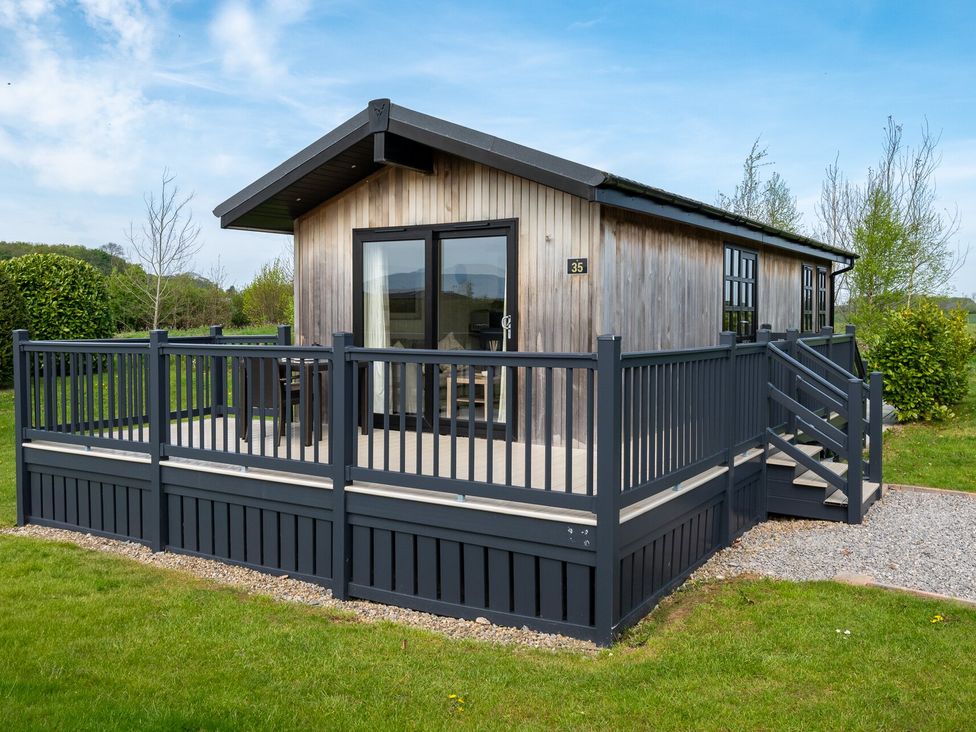 A cabin with a deck and railing in Stokesley (Pet) Great Ayton