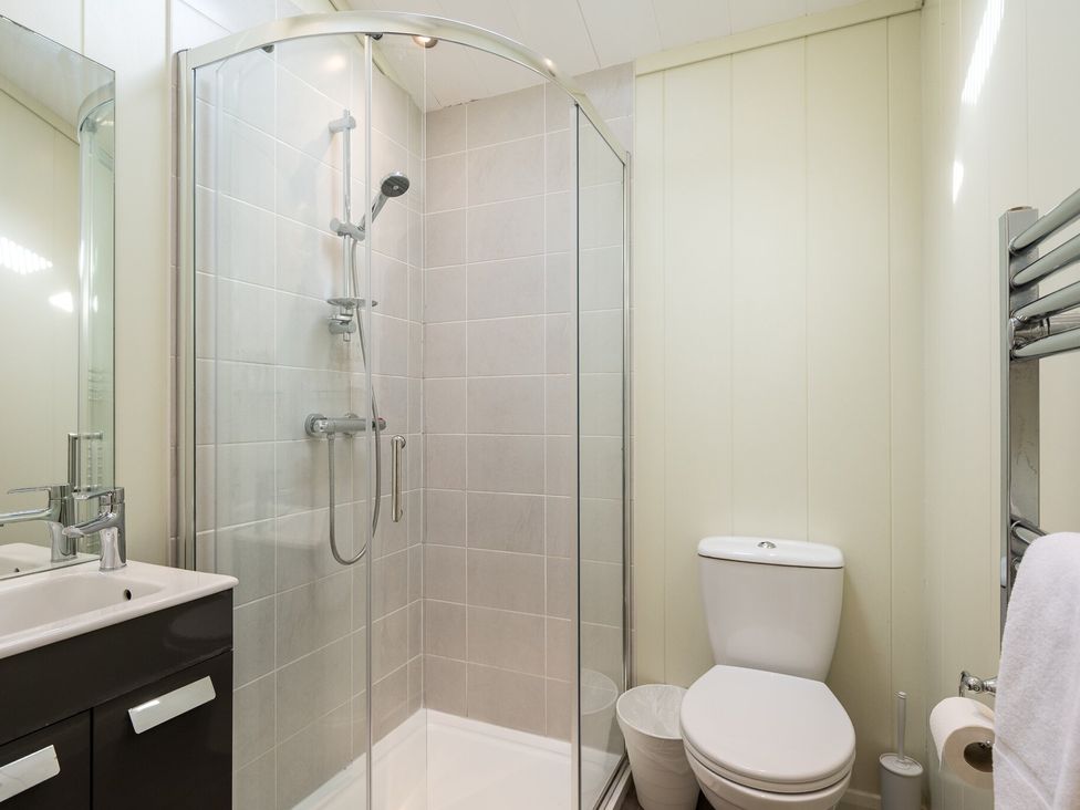 A bathroom with a shower, sink, toilet, and towel rail at Stokesley (Pet) Great Ayton