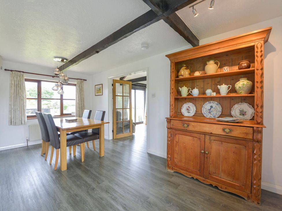 A dining room with a table and chairs at Long Linney in Bideford