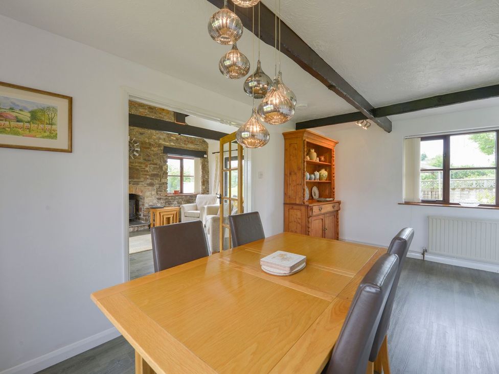 A dining room with a table and chairs at Long Linney in Bideford