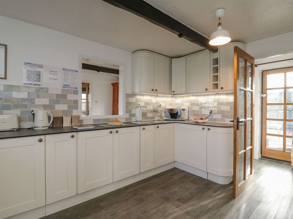 A kitchen with a microwave and kettle at Long Linney in Bideford