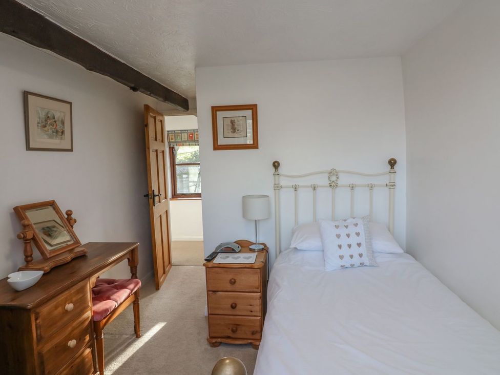 A bedroom with a bed and a desk at Long Linney in Bideford