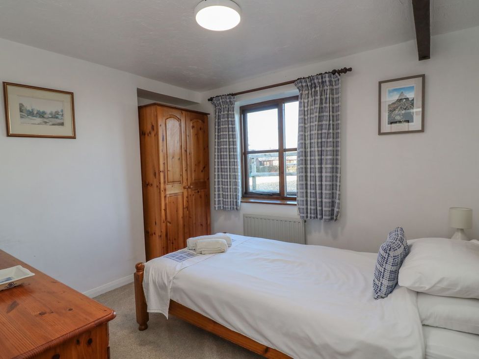 A bedroom with a single bed and wardrobe at Long Linney in Bideford