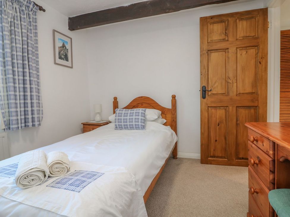 A bedroom with a bed and bedside table at Long Linney in Bideford