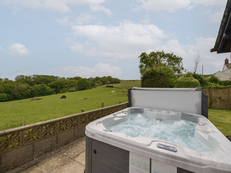 An outdoor area with a hot tub and grass at Long Linney in Bideford