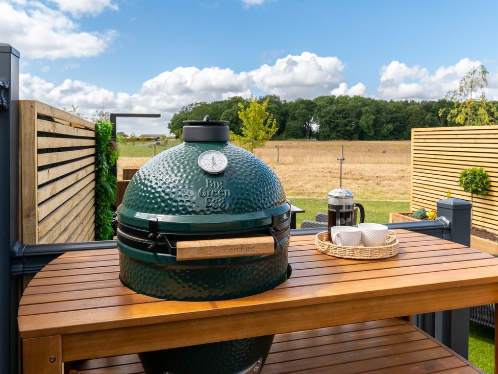 A Big Green Egg grill on an outdoor table at The Oasis in Great Ayton