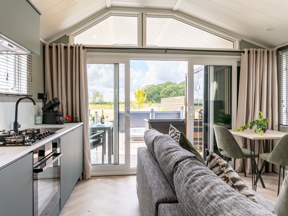 A living room with a kitchen and dining area at The Oasis in Great Ayton
