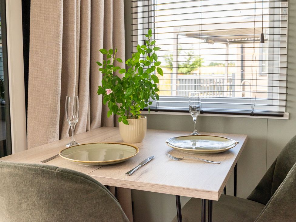 A dining table set with plates and glasses at The Oasis in Great Ayton