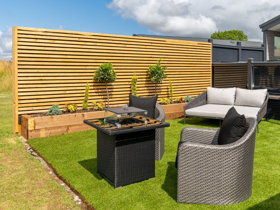 A seating area with a table and chairs at The Oasis in Great Ayton