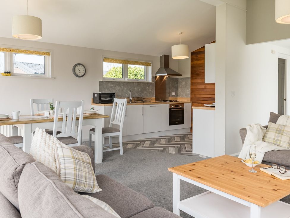 A living room with a sofa and dining table at Greystone in Great Ayton