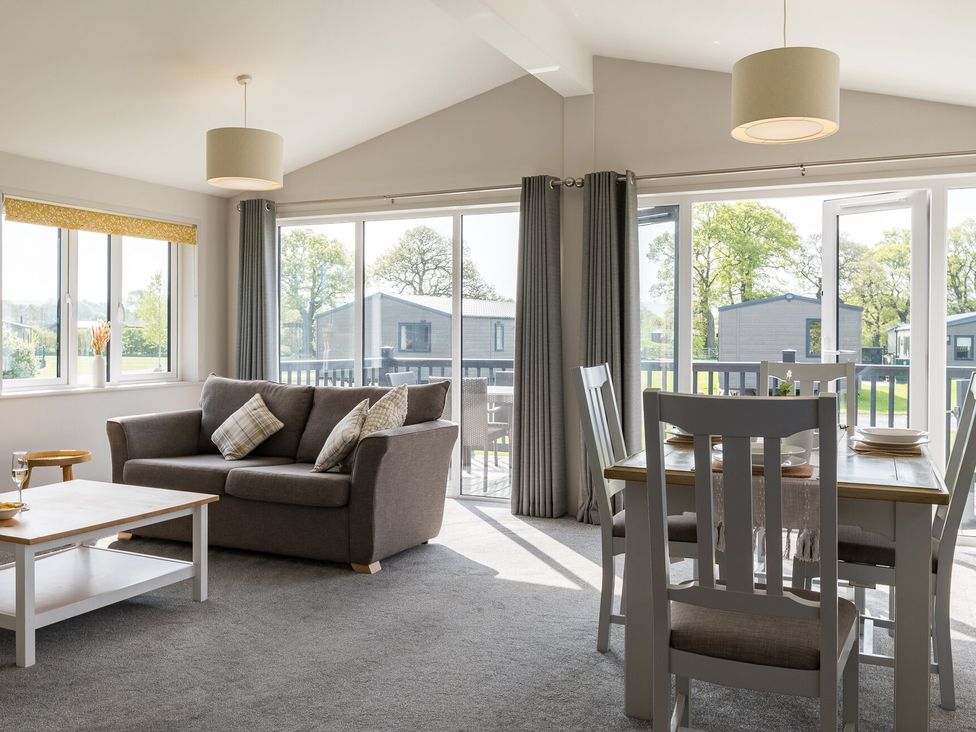 A living room with a sofa and dining table at Greystone in Great Ayton