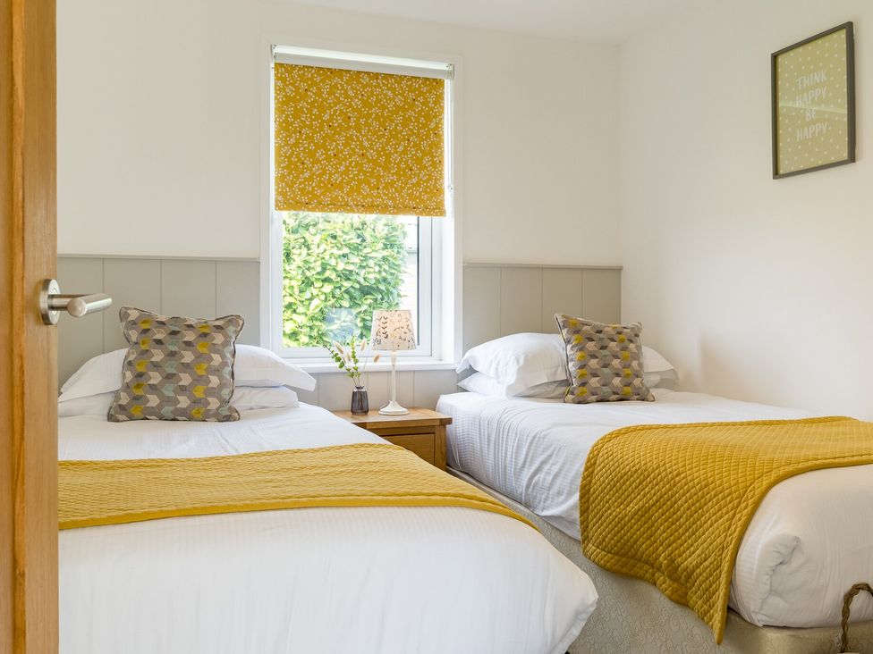 A bedroom with two beds and a window at Greystone in Great Ayton