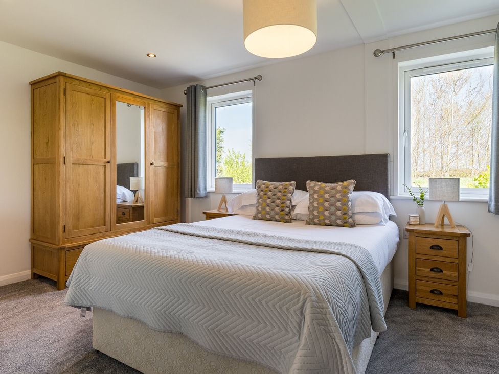 A bedroom with a bed and wardrobe at Greystone in Great Ayton