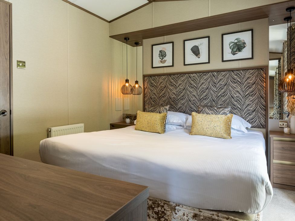 A bedroom with a bed and wall art at The Woods in Great Ayton