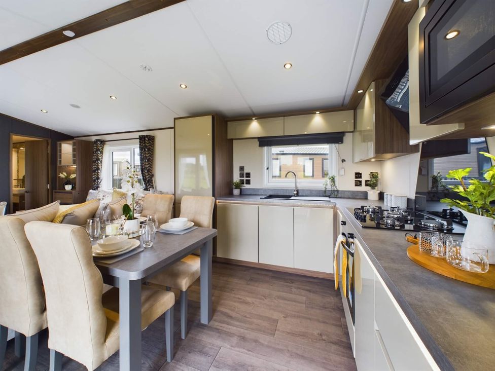 A kitchen with a dining area and various appliances at The Woods in Great Ayton