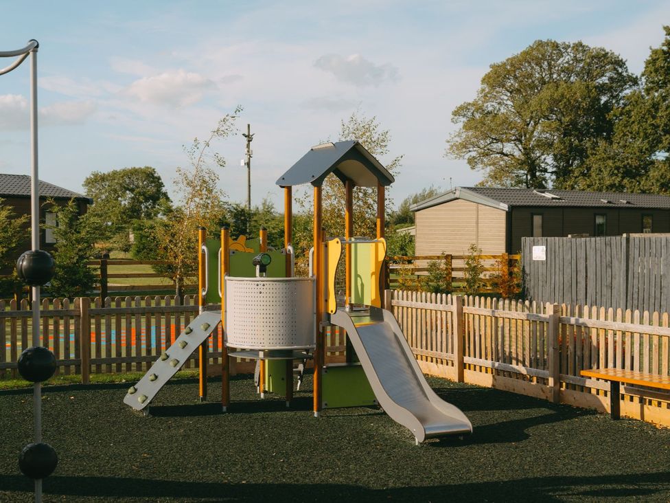 A playground with a slide and climbing frame at The Woods in Great Ayton
