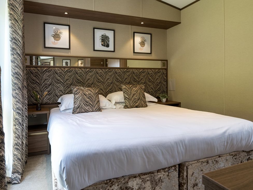 A bedroom with a bed and bedside table at The Woods (Pet) Great Ayton