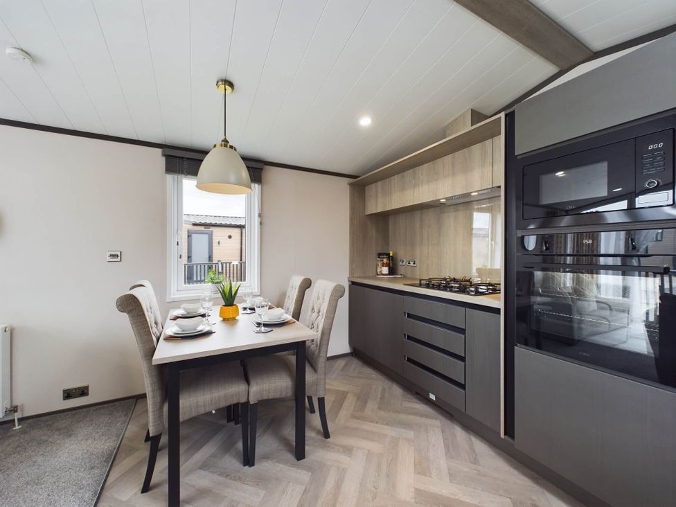 A kitchen with a dining table and chairs at The Woods (Pet) Great Ayton