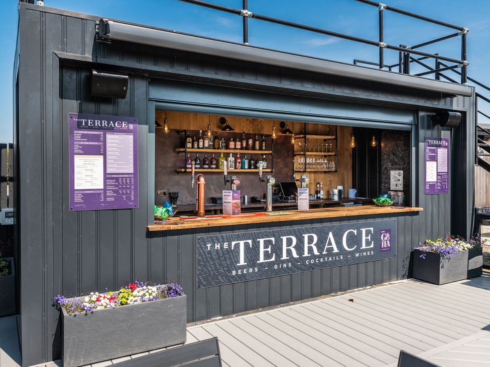 An outdoor bar with a menu board and drinks at The Woods (Pet) Great Ayton