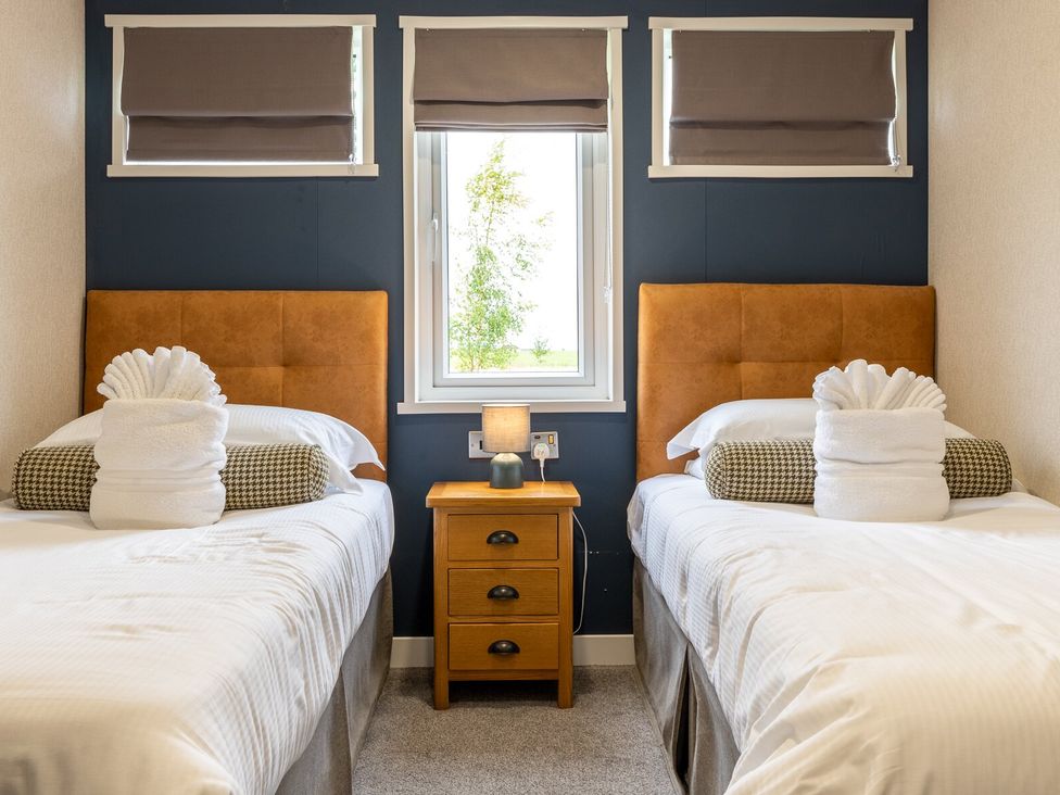 A bedroom with two beds and a nightstand at Rosedale in Great Ayton