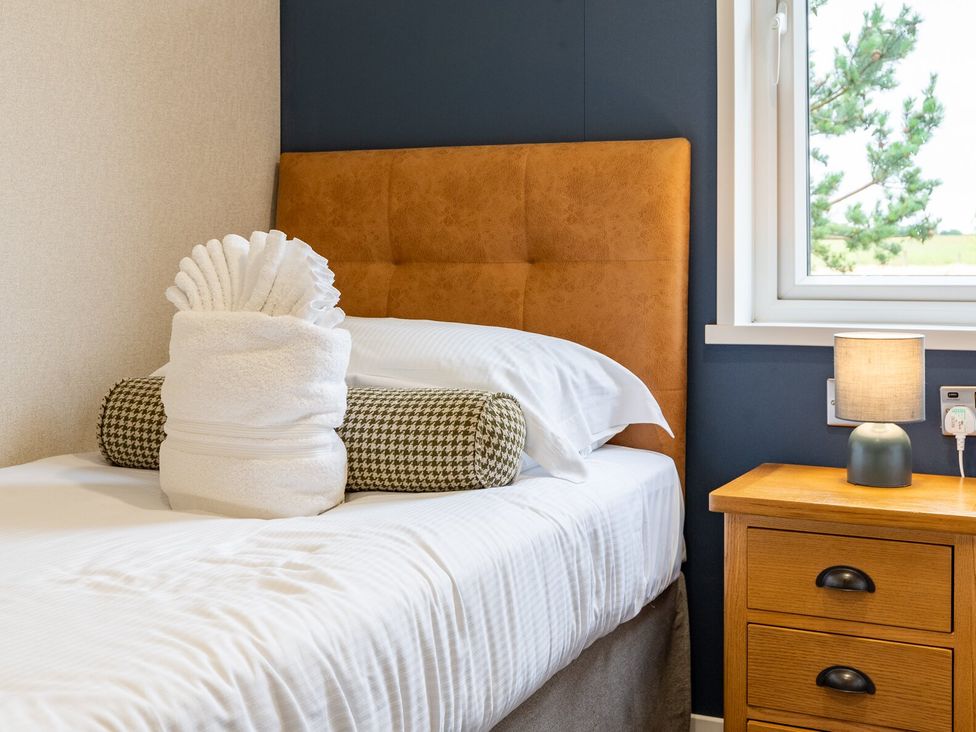 A bedroom with a bed and a nightstand at Rosedale in Great Ayton