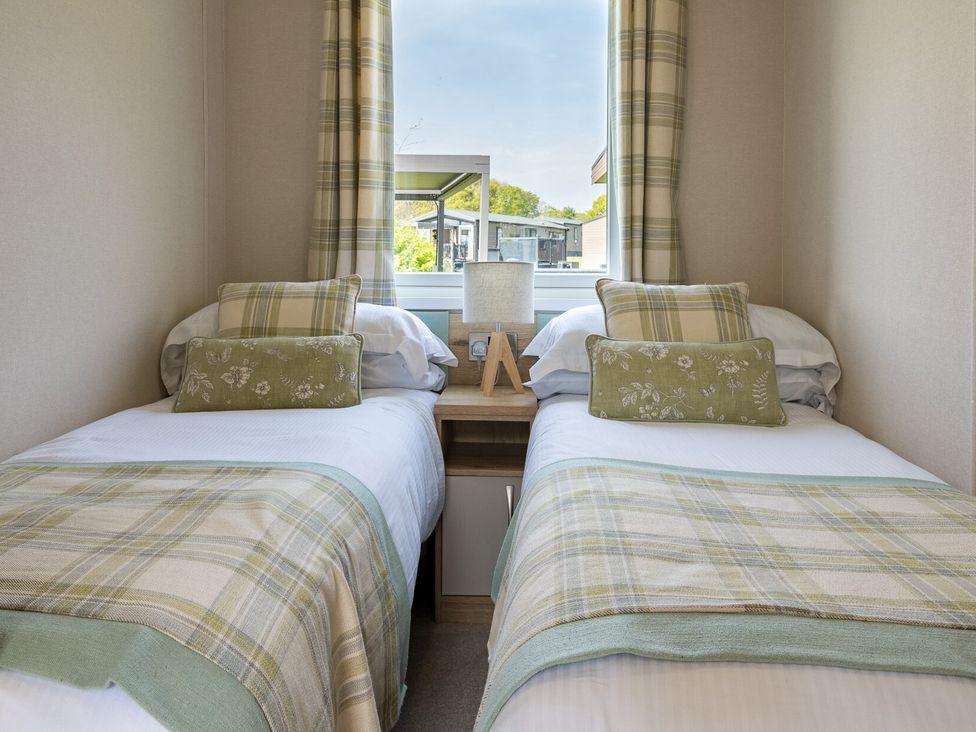 A bedroom with two single beds and a bedside table at Leven (Pet) Great Ayton