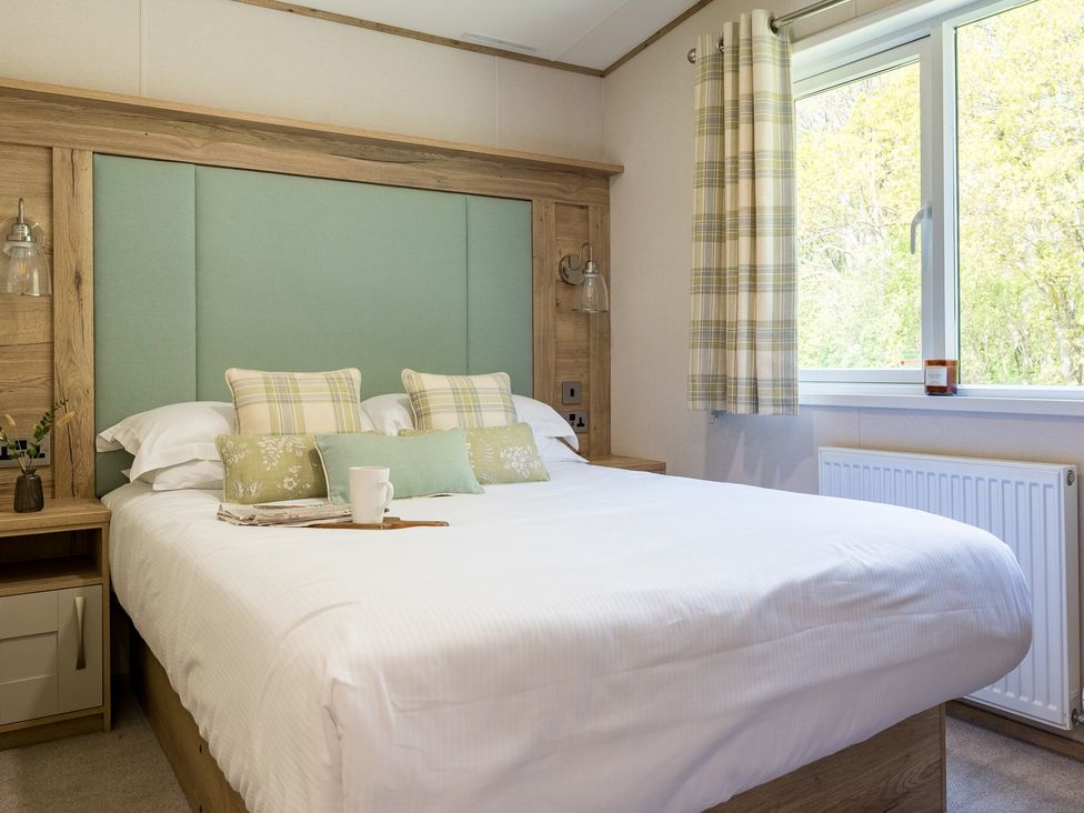 A bedroom with a bed and window at Leven (Pet) Great Ayton