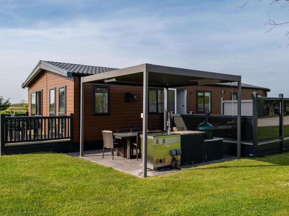 A house with a deck and patio furniture at Roseberry in Great Ayton
