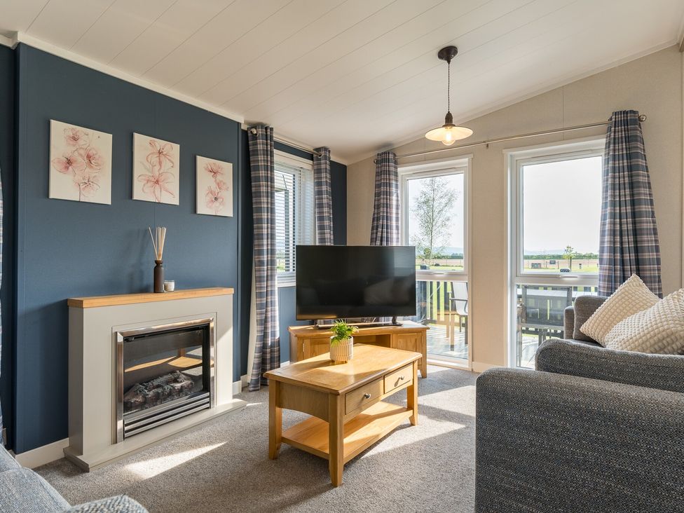 A living room with a television and sofa at Roseberry in Great Ayton