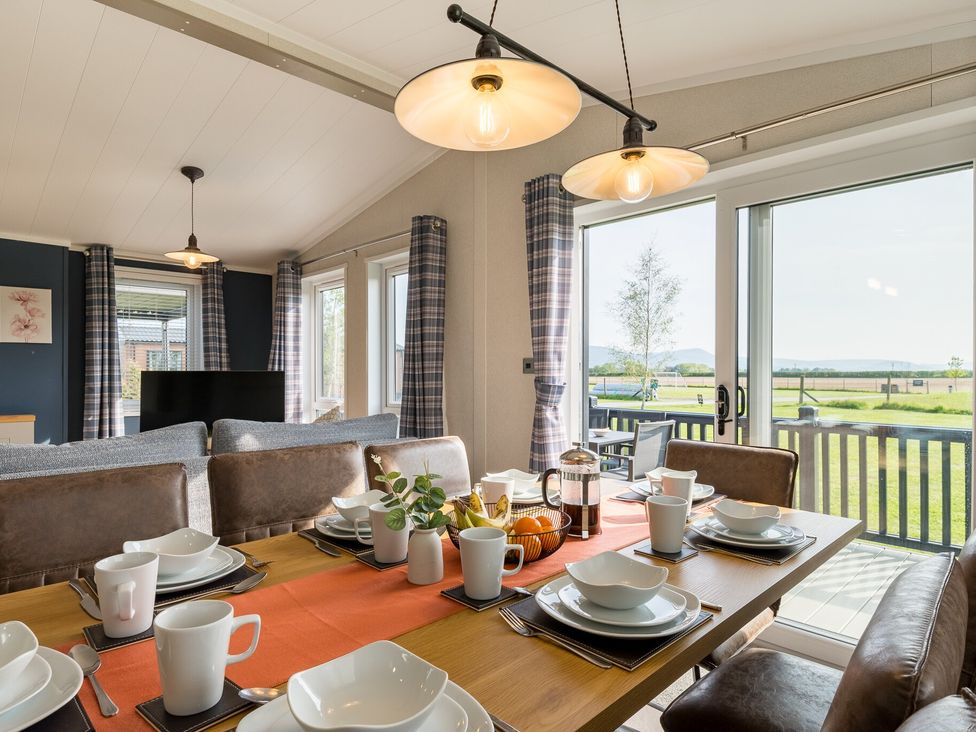 A dining room with a table set for meals at Roseberry in Great Ayton