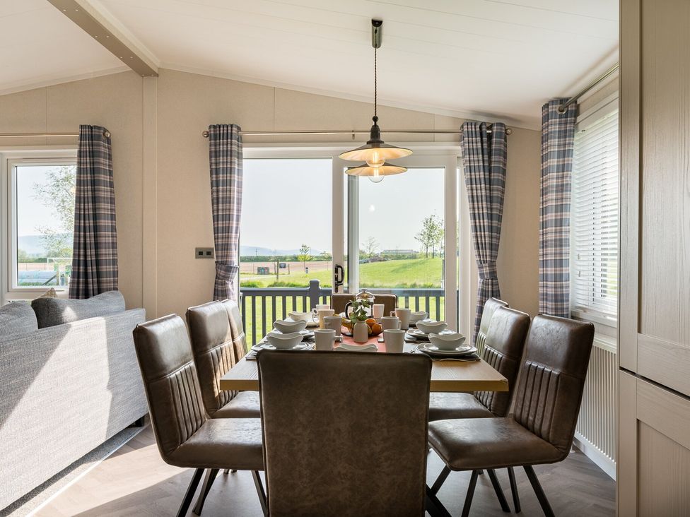 A dining room with a table set for dinner at Roseberry in Great Ayton