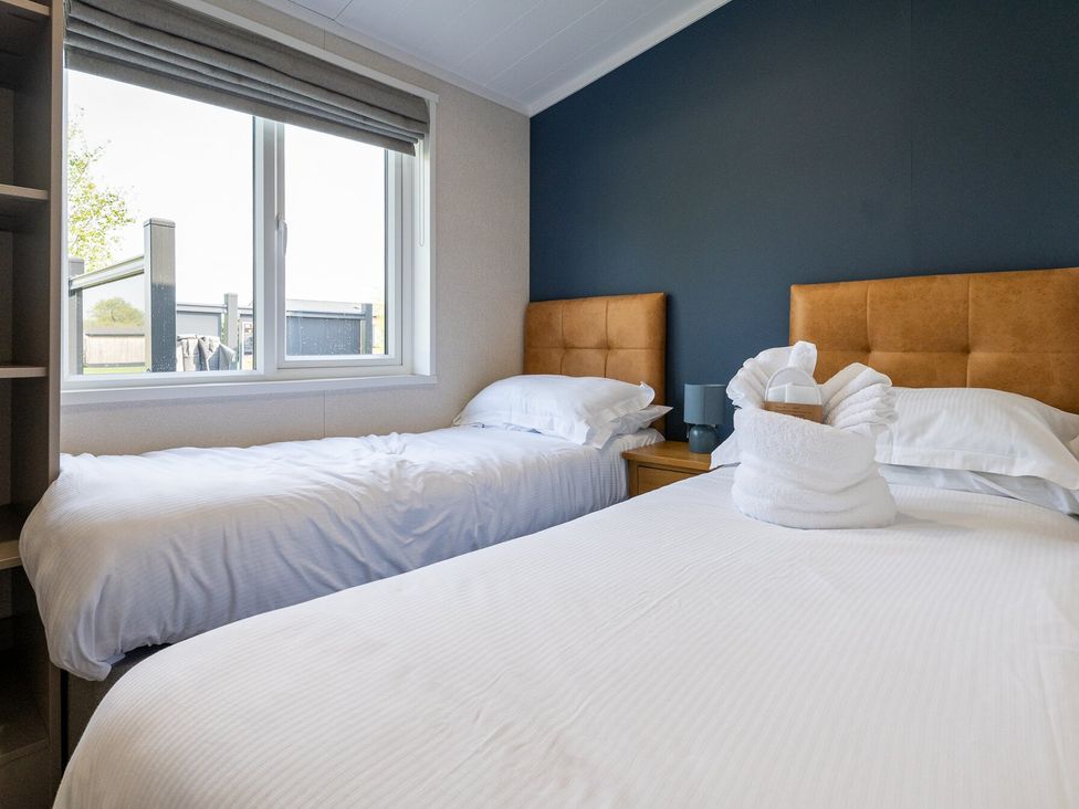 A bedroom with two beds and a window at Roseberry in Great Ayton