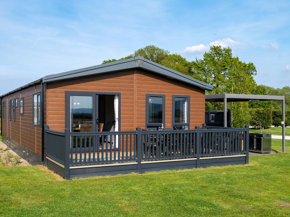 A cabin with deck and grass area at Roseberry (Pet) Great Ayton