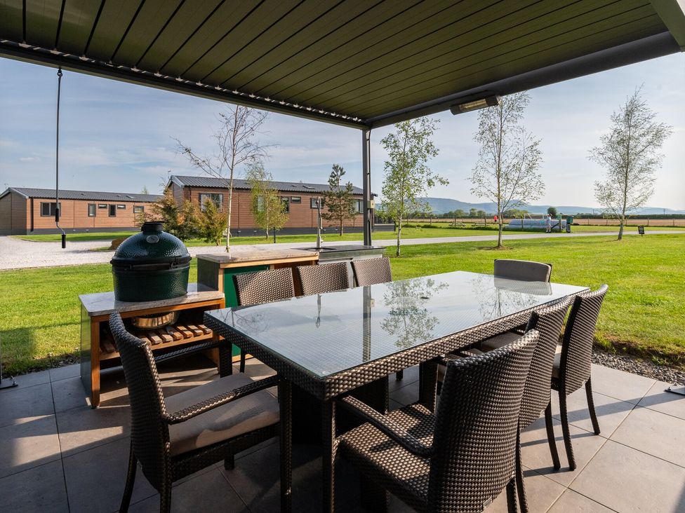 An outdoor dining area with a table and chairs at Roseberry (Pet) Great Ayton