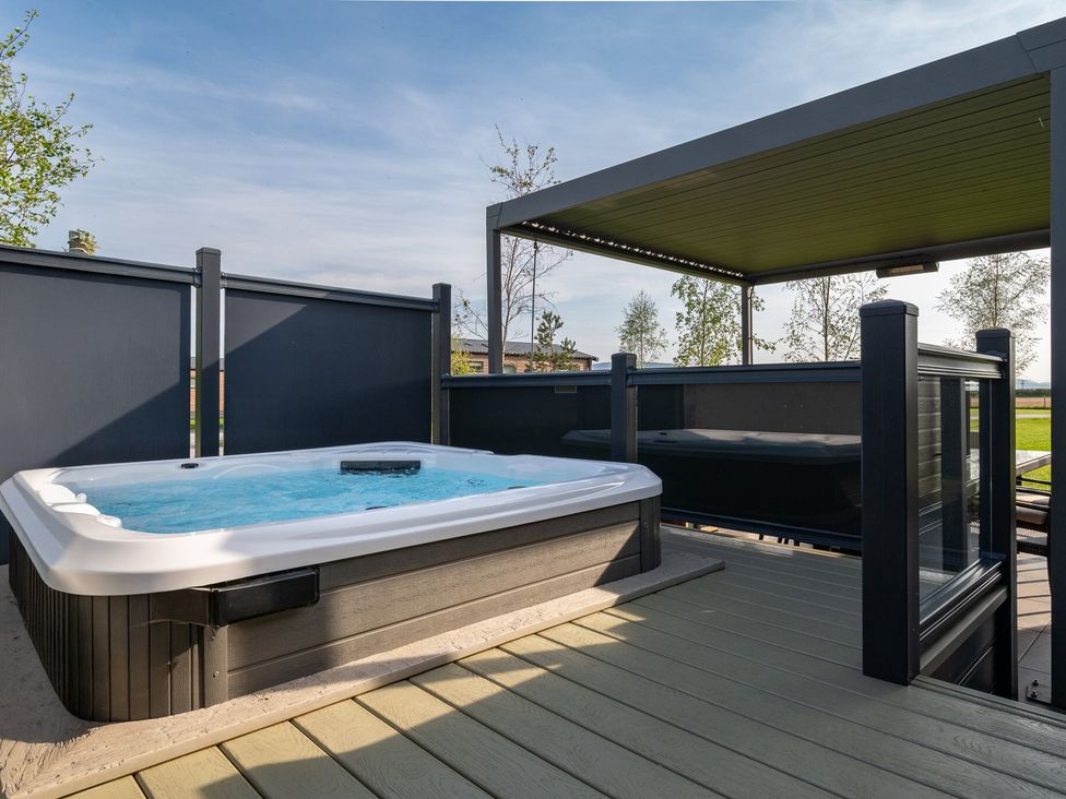 A hot tub on a deck with railings at Roseberry (Pet) in Great Ayton