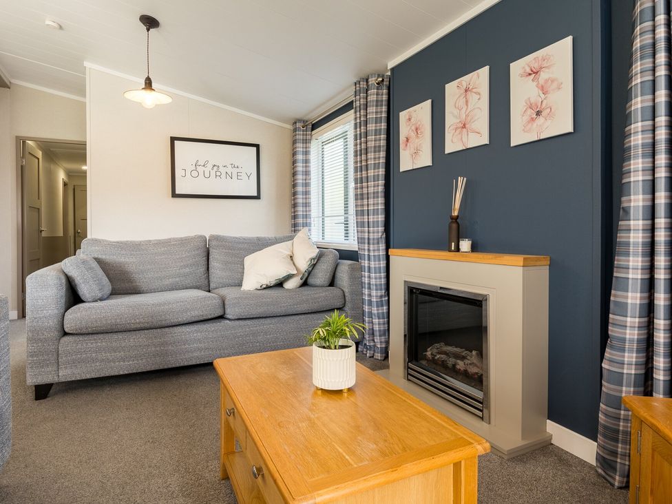 A living room with a sofa and a fireplace at Roseberry (Pet) in Great Ayton