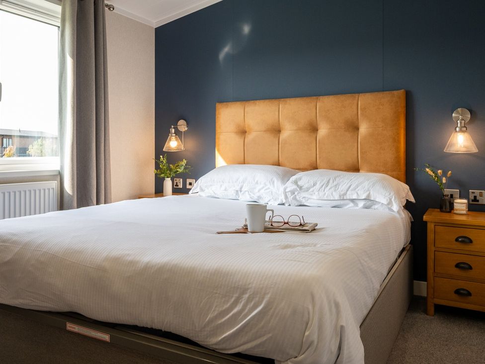 A bedroom with a bed and bedside table at Roseberry (Pet) Great Ayton