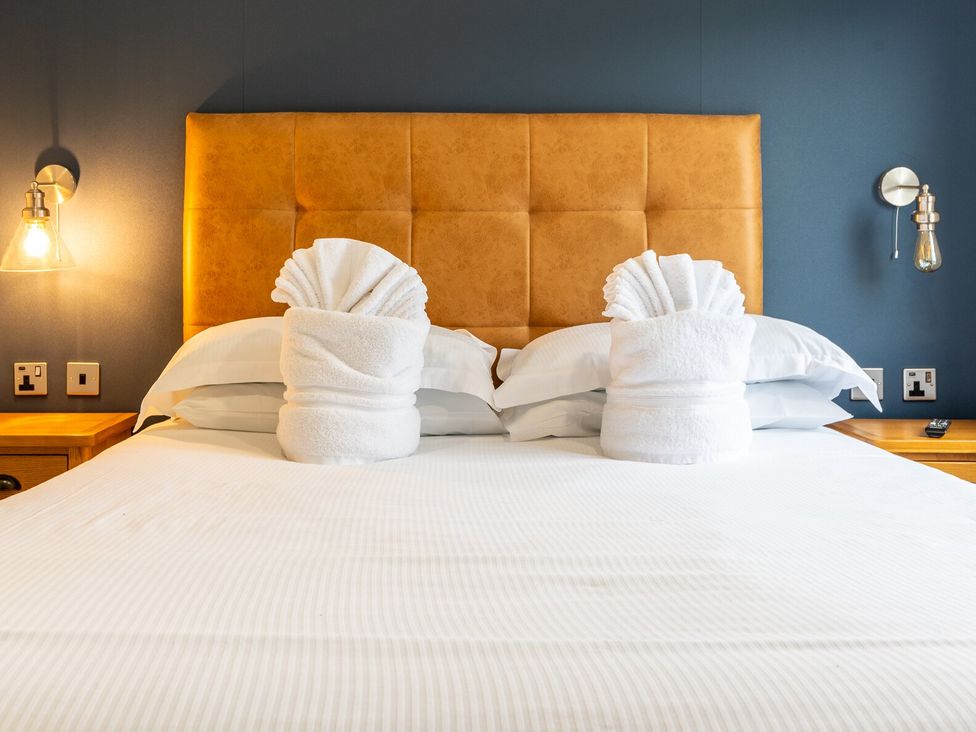 A bedroom with a bed and towel origami at Roseberry (Pet) Great Ayton