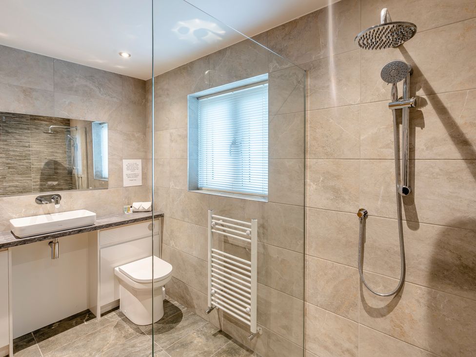 A bathroom with a shower and sink at Tranquillity 3 (Pet) in Carnforth