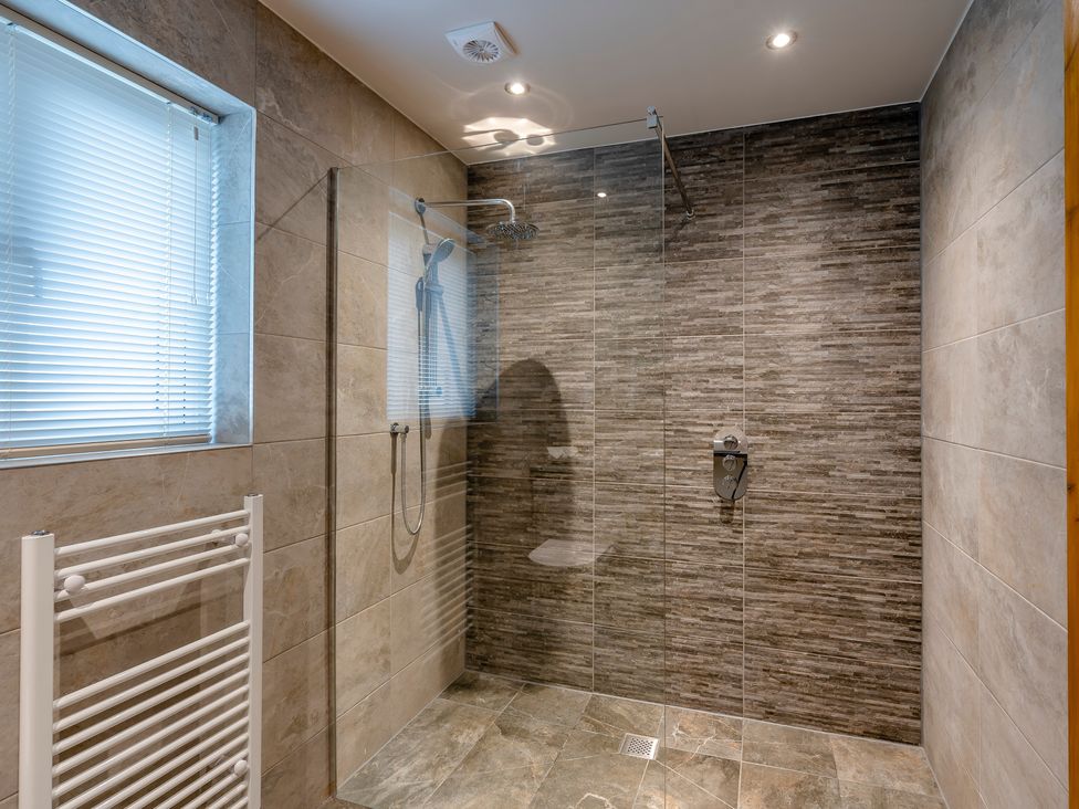 A bathroom with a shower enclosure and towel radiator at Tranquillity 3 (Pet) Carnforth